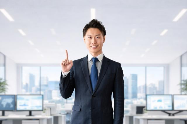 人差し指を立てて案内する男性ビジネスマン